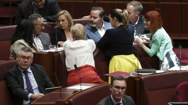 Greens leader Richard Di Natale in discussion with Greens senators in Parliament.