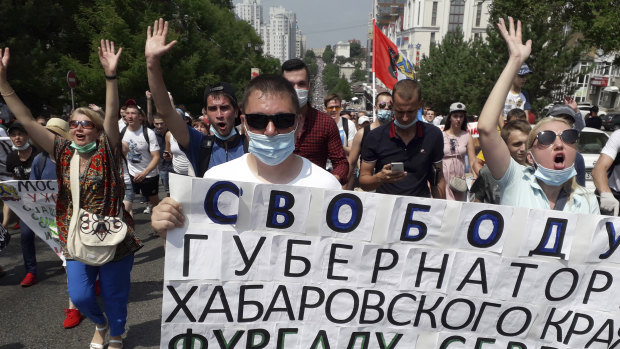 People hold posters reading "Freedom for Khabarovsk region's governor Sergei Furgal" during an unsanctioned protest.