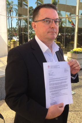 Logan mayor Luke Smith with the letter from Local Government Minister Stirling Hinchliffe, which formally suspended him.