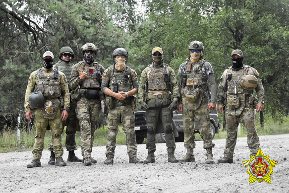 Belarusian soldiers of the Special Operations Forces and mercenary fighters from Wagner private military company pose for a photo while on manoeuvres near the border city of Brest, Belarus. 