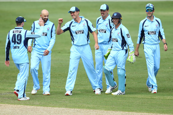 Pat Cummins celebrates with Blues teammates after running out Jake Fraser-McGurk of Victoria.