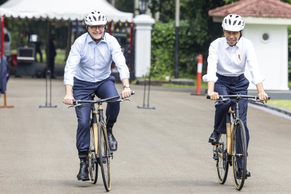 Albanese and Widodo ride bicycles around the palace grounds at Bogor Palace in Indonesia on June 6, 2022. 