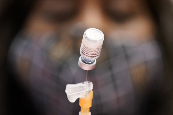 A certified medical assistant prepares a dose of the Pfizer-BioNTech COVID-19 vaccine at a vaccination.