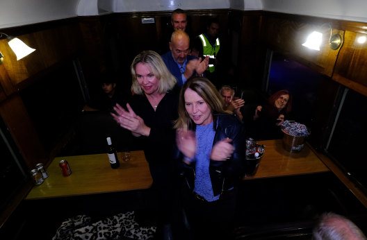 Monica Godde left, and her sister Rachel Godde enjoy the music.