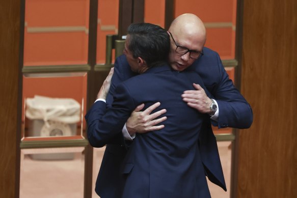 Simon Birmingham and Peter Dutton hug after the former announced his retirement from politics.