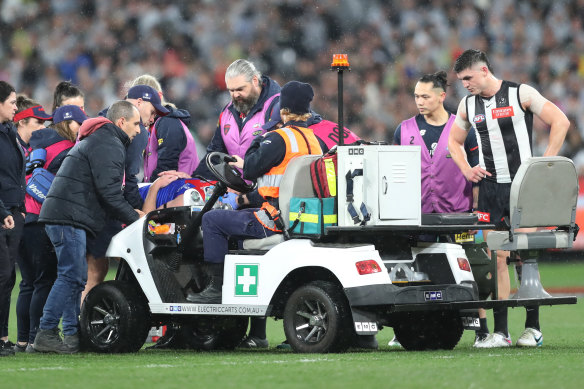 Brayden Maynard watches on as Angus Brayshaw is stretchered off the field.