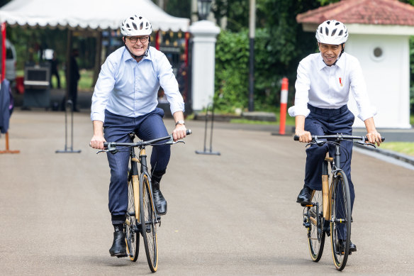 Prime Minister Anthony Albanese and Indonesian President Joko Widodo cycle through Bogor Palace in Indonesia on Monday.