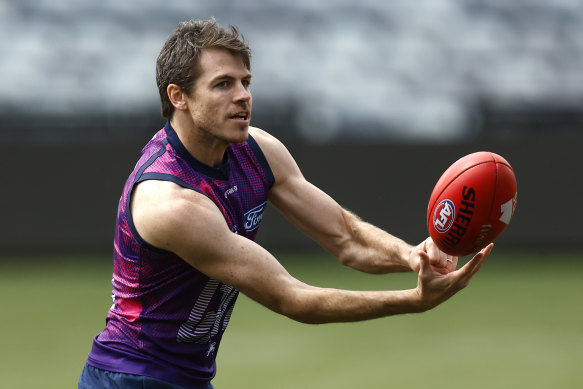 Smith fires off a handball at training on Monday.