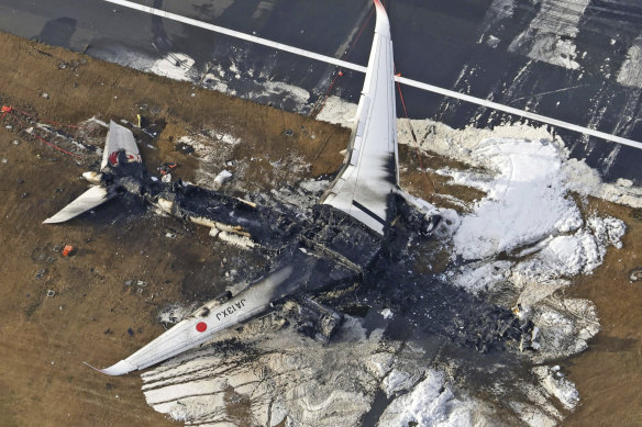 The burnt-out Japan Airlines plane that collided with another aircraft on Tuesday evening. All 379 passengers and crew safely evacuated, though five people on board the other plane were killed.