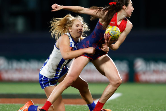 Melbourne’s Alyssa Bannan is tackled by Lulu Pullar of the Kangaroos. 