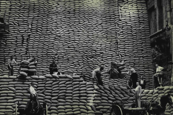 Before containers, wharf labourers such as these men in Sydney in 1954 unloaded sacks by hand.