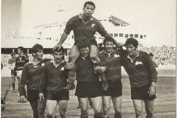 John Sattler, suffering a broken jaw, is chaired off by Bob McCarthy and Souths teammates after the Rabbitohs beat Manly in the 1970 grand final.
