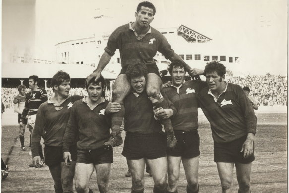 John Sattler, suffering a broken jaw, is chaired off by Bob McCarthy and Souths teammates after the Rabbitohs beat Manly in the 1970 grand final.