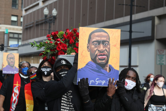 Demonstrators carry a symbolic coffin and images of George Floyd during an ‘I Can’t Breathe’ Silent March For Justice in Minneapolis, Minnesota, ahead of the trial.
