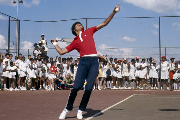 Arthur Ashe carries out a demonstration at the local tennis centre for young South African children in Soweto.