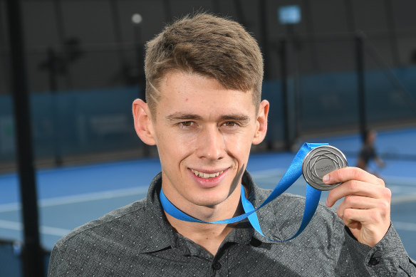 Alex de Minaur with his medal last year. 