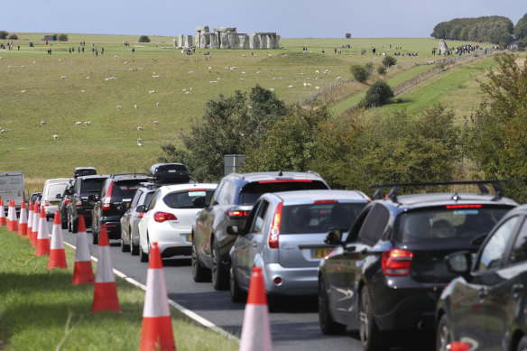 Traffic builds up on the main road near Stonehenge, which can be seen in the background.