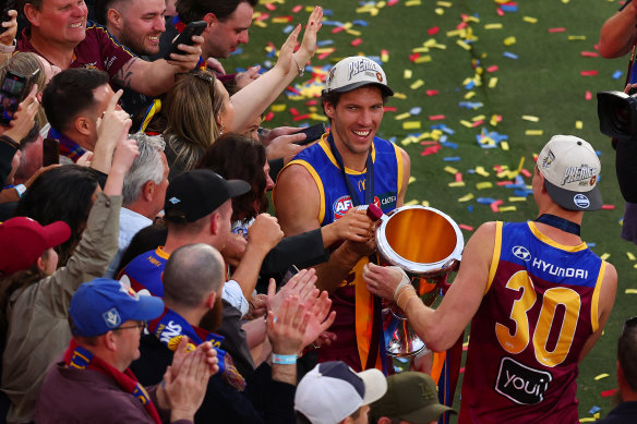 Darcy Fort celebrates with the premiership cup.