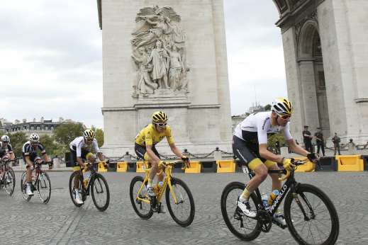 Competitors in the Tour de France pass the Arc de Triomphe in Paris. 