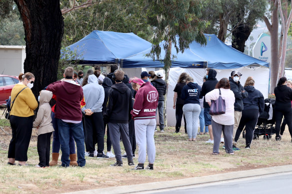 Queues of people line up for a COVID-19 test in Adelaide on Monday. 
