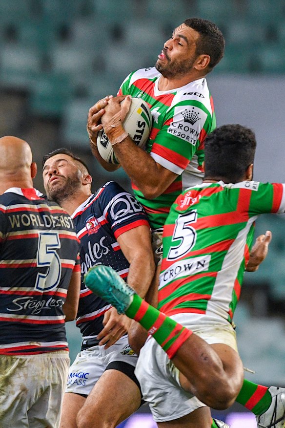 High flyer: Greg Inglis pulls in a Adam Reynolds bomb before scoring.