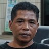 Bejo Santoso (right) with Muhamad Kholil, who is waiting for news on his missing wife, Siti.