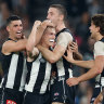 Collingwood’s Joe Richards, middle, is mobbed by his teammates after kicking his first AFL goal.