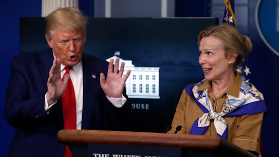 President Donald Trump reacts as Dr. Deborah Birx, White House coronavirus response coordinator, speaks about her granddaughter's fever as she speaks about the coronavirus in the James Brady Press Briefing Room of the White House, Monday, April 6, 2020, in Washington. (AP Photo/Alex Brandon)