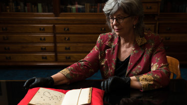 Maggie Patton, chief curator at the  State Library of NSW, with a 1516 letter containing a drawing of the Southern Cross, thought to be the oldest European depiction. 