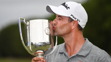 Australian golfer Adam Scott kisses the trophy after winning the 2019 Australian PGA Championship at the RACV Royal Pines Resort on the Gold Coast. 