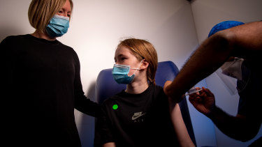 Twelve-year-old Eve, accompanied by her mum Narelle, having her first coronavirus vaccination in Melbourne last week.