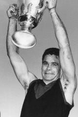 Ron Barassi holds the 1964 premiership cup aloft.