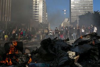 Demonstrators clash with riot police during a protest against Brazilian President Jair Bolsonaro amid the coronavirus pandemic at Paulista Avenue in Sao Paulo.