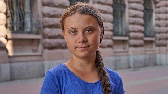 Climate activist Greta Thunberg stands next to Swedish parliament in Stockholm on Friday. The teenager often travels by train in Europe and will now sail to the US.