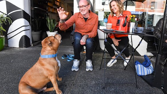 Frank, his owner Mick Barnes, and vet Leigh Davidson at the Black Toast cafe in Annandale. 
