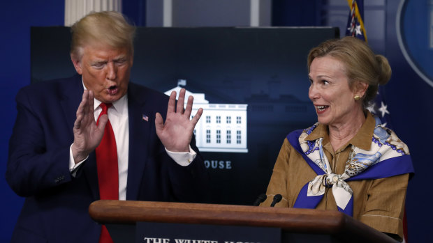 President Donald Trump reacts as Dr Deborah Birx  speaks about her granddaughter's fever.