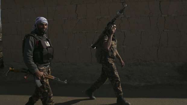 Security forces arrive after a powerful suicide bombing targeted an under-construction medical facility near the Bagram Air Base.