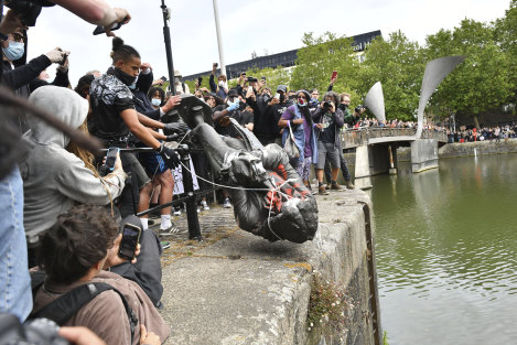 Protesters throw a statue of slave trader Edward Colston into Bristol harbour, June 7.