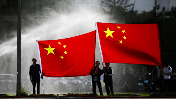 People wait for Chinese Premier Li Keqiang outside the German chancellery in Berlin last month.