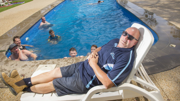 Lake Eppalock Holiday Park owner and operator Peter Rose gets a rare moment's rest by the pool during the summer school holiday peak.