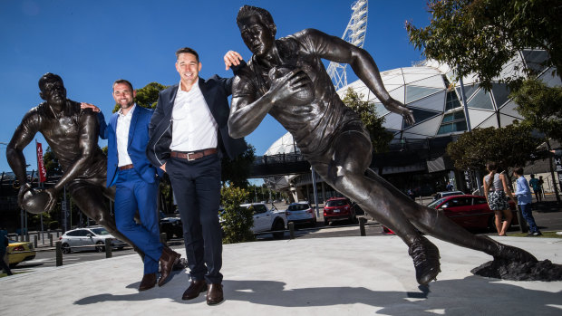 Storm legends Cameron Smith and Billy Slater with their statues at AAMI Park last week.