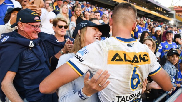 Michelle Arthur shares a special moment with Jakob after the 18-year-old scored a try on debut in Brisbane on Sunday.