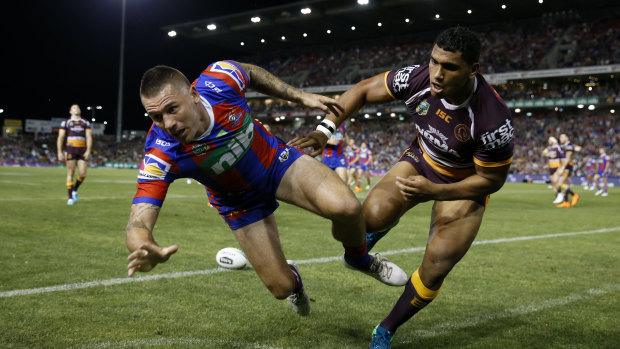 Doesn't count: Shaun Kenny-Dowall of the Knights is bowled over the dead ball line after having a try disallowed.