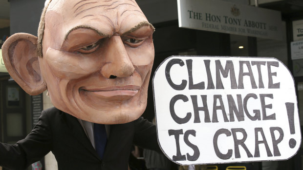 A demonstrator with a giant head in the likeness of former prime minister Tony Abbott holds a sign referencing his 2017 remark belittling the science of climate change during a student-organised protest in Sydney this month. 