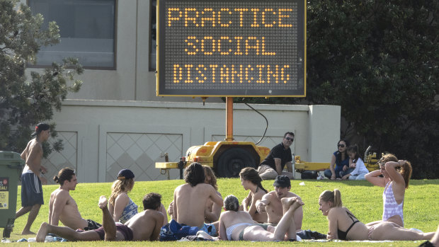 A group of people in Melbourne on Friday. The next day, Victorian police passed legislation for on-the-spot fines for people breaching social distancing rules. 