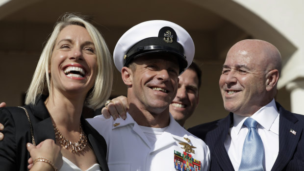 Navy Special Operations Chief Edward Gallagher, centre, leaves court with his wife Andrea, left, in July after being acquitted of murder.