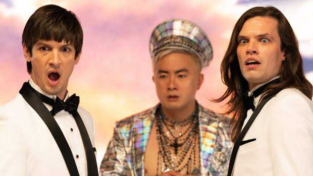 Twins Craig (Josh Sharp) and Trevor (Aaron Jackson) with Bowen Yang as a blinged-up God.