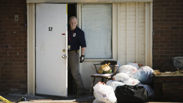 Investigators comb the scene of the five murders in a Morrisville apartment.