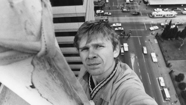 Steeplejack Tom Smetana at the top of a flagpole 70 metres above street level in 1984.