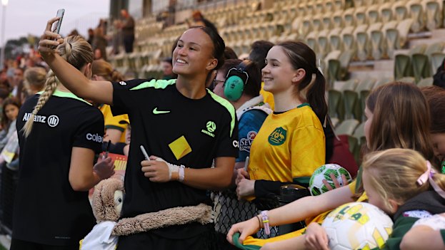 Taking a selfie with fans at a Matildas training session in Perth.
